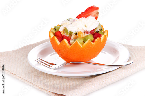 Fruit salad in hollowed-out orange isolated on white