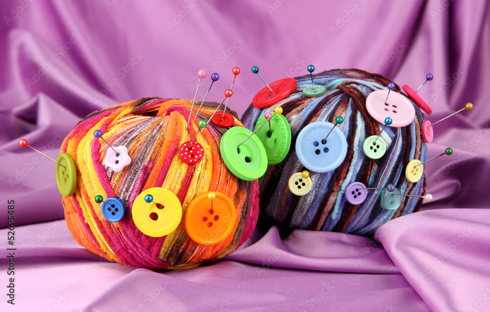 Colorful buttons and multicolor wool balls,