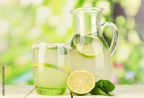 Citrus lemonade in pitcher and glass photo