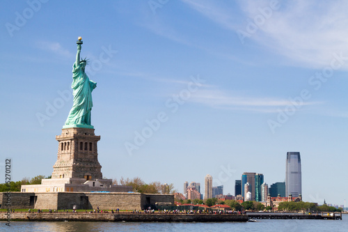 Statue of Liberty, and Manhattan Skyline behind it © wawri