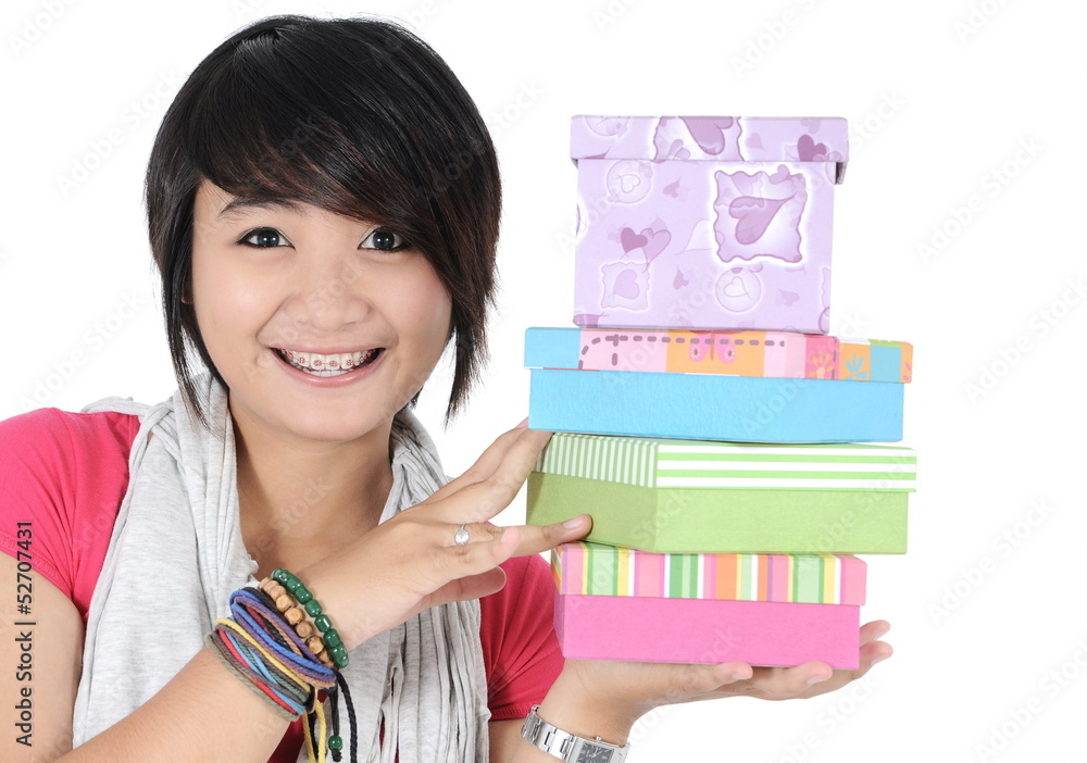 beautiful girl smiling and holding a stack of gifts, isolated