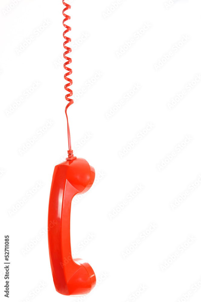 Isolated dangling red retro telephone receiver on white Isolated dangling red retro telephone receiver on white