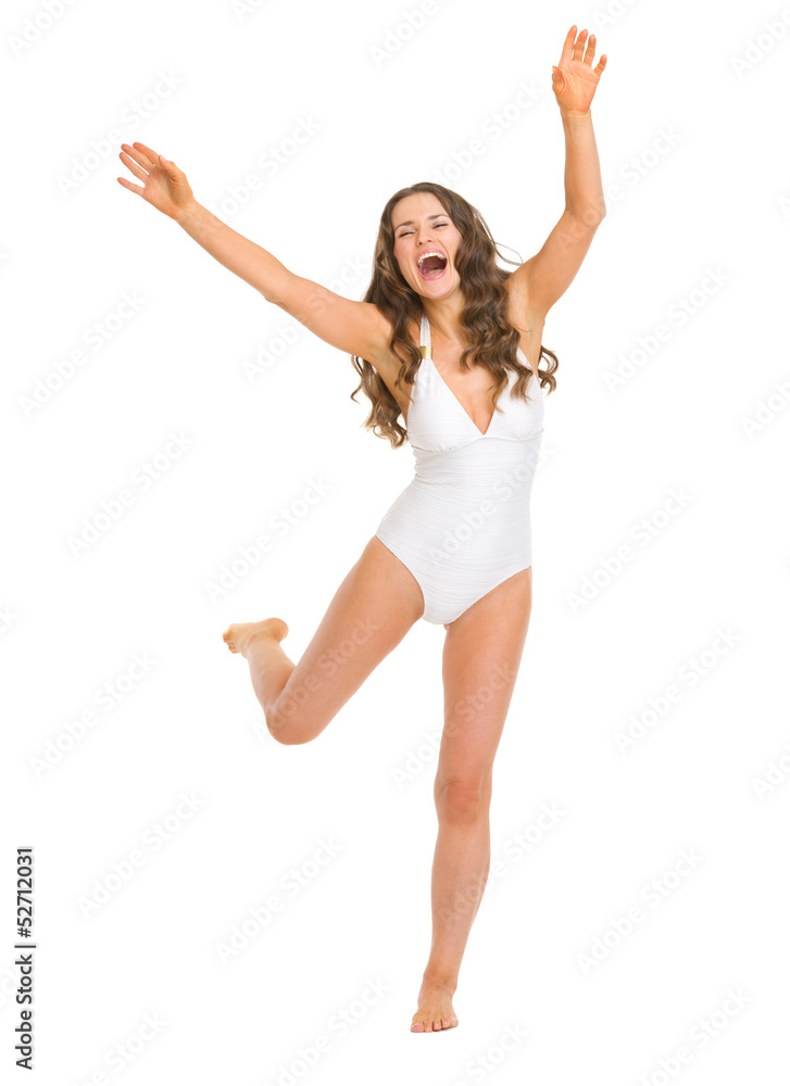 Full length portrait of cheerful young woman in swimsuit