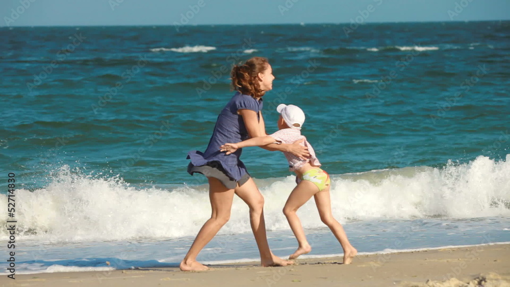 mother and child playing on the beach mother and child playing on the beach
