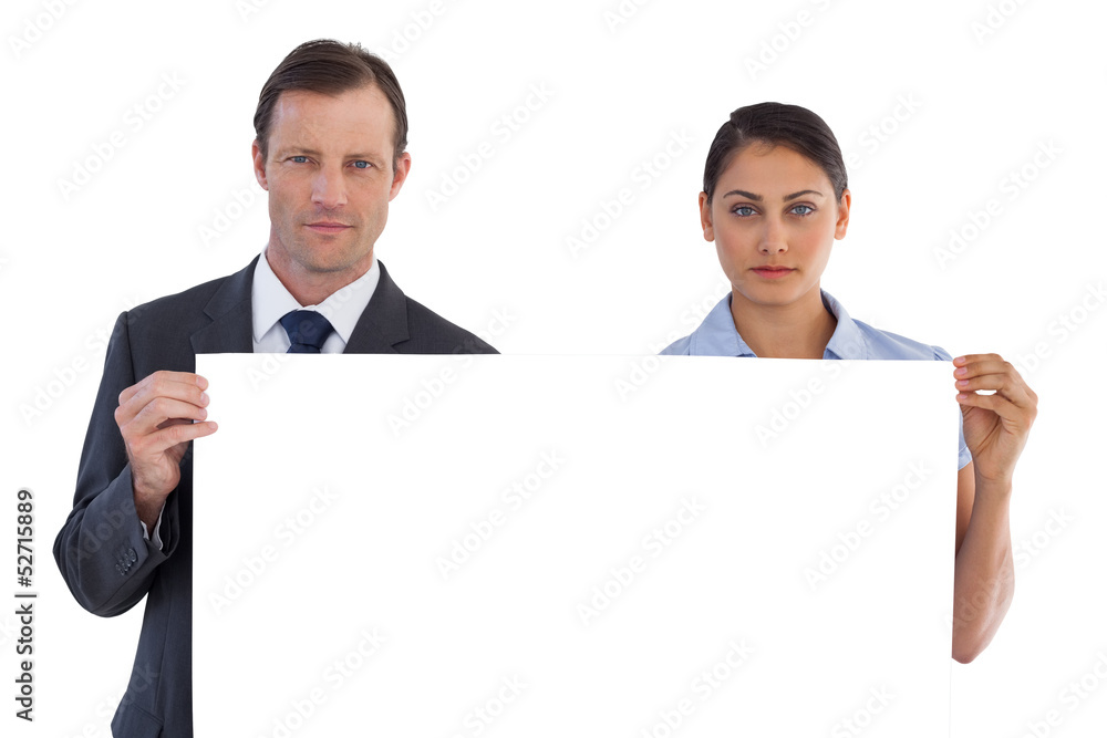 Serious co workers holding a blank copy space Serious co workers holding a blank copy space