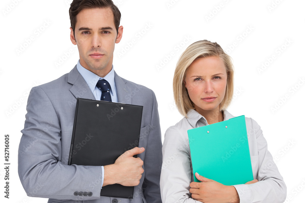 Serious business people standing together with folders Serious business people standing together with folders