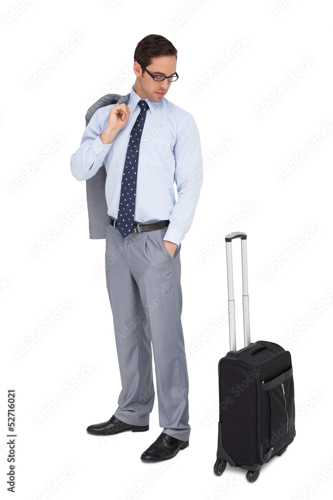 Serious businessman looking at his luggage Serious businessman looking at his luggage