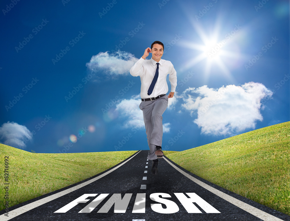 Smiling businessman running on a road Smiling businessman running on a road