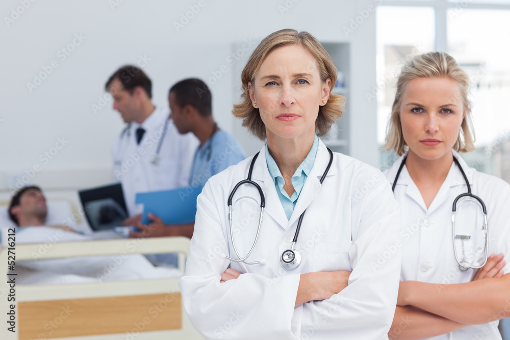 Two serious women doctors standing Two serious women doctors standing