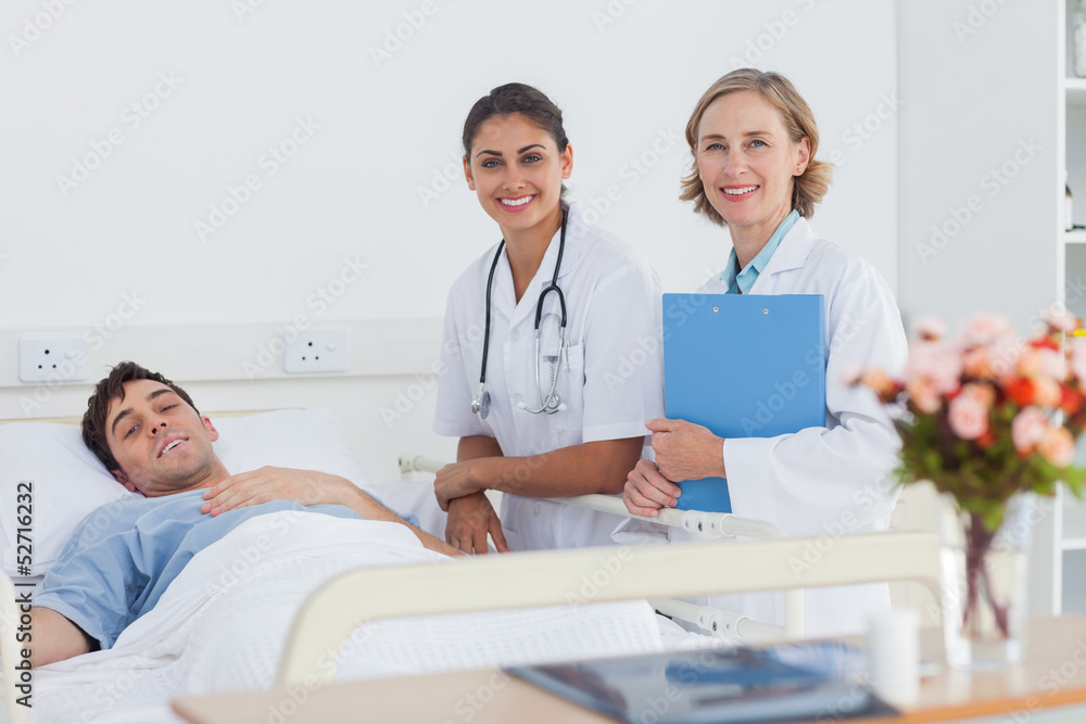 Two doctors and a patient looking at the camera Two doctors and a patient looking at the camera