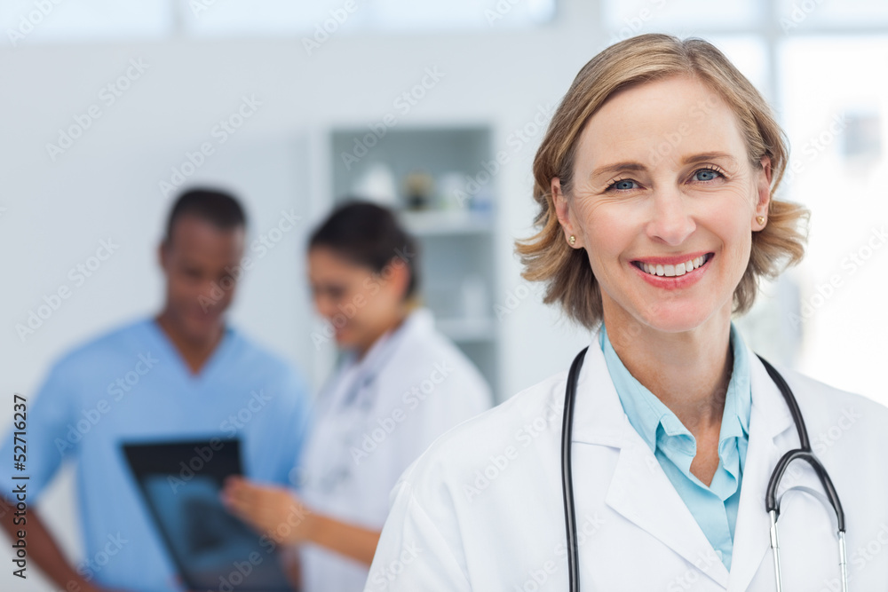 Woman doctor smiling and looking to the camera Woman doctor smiling and looking to the camera