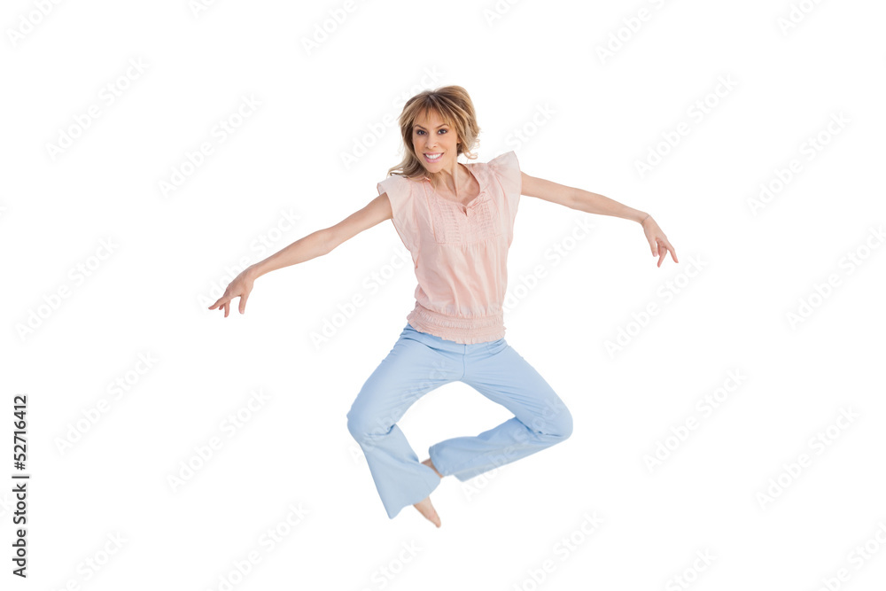 Woman jumping and opening arms