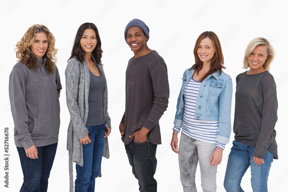 Fashionable young people in a line smiling Fashionable young people in a line smiling