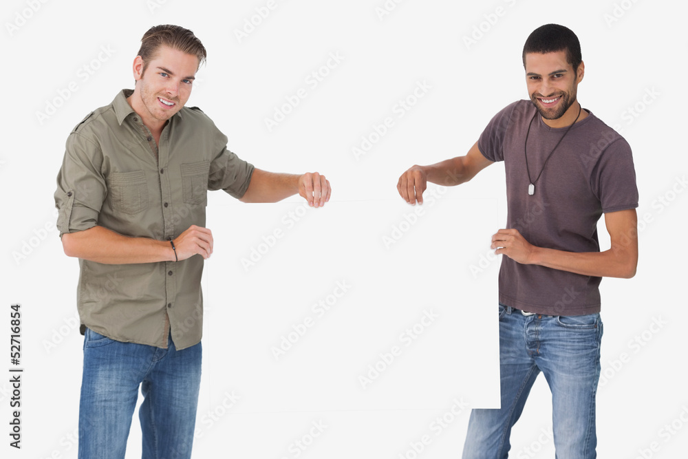 Attractive men holding blank card and looking at camera Attractive men holding blank card and looking at camera