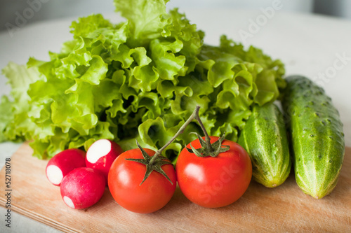 fresh tomatos, cucumbers, radish and salad on the kitchen