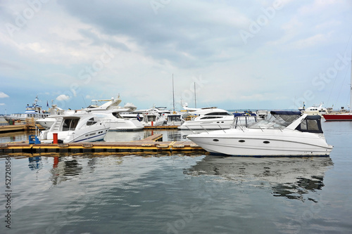 White motor yacht over harbor pier, Odessa, Ukraine