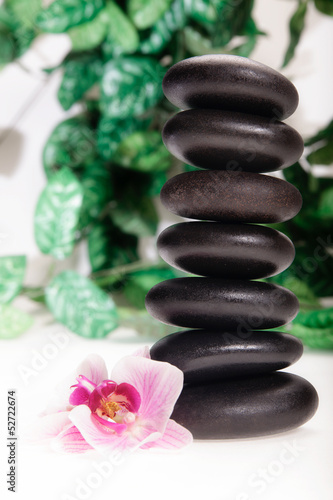 Stacked massage stones and orchid