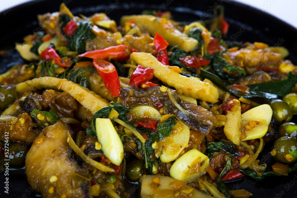 Fried fish with fresh herbs and spicy sauce served on iron hot Fried fish with fresh herbs and spicy sauce served on iron hot