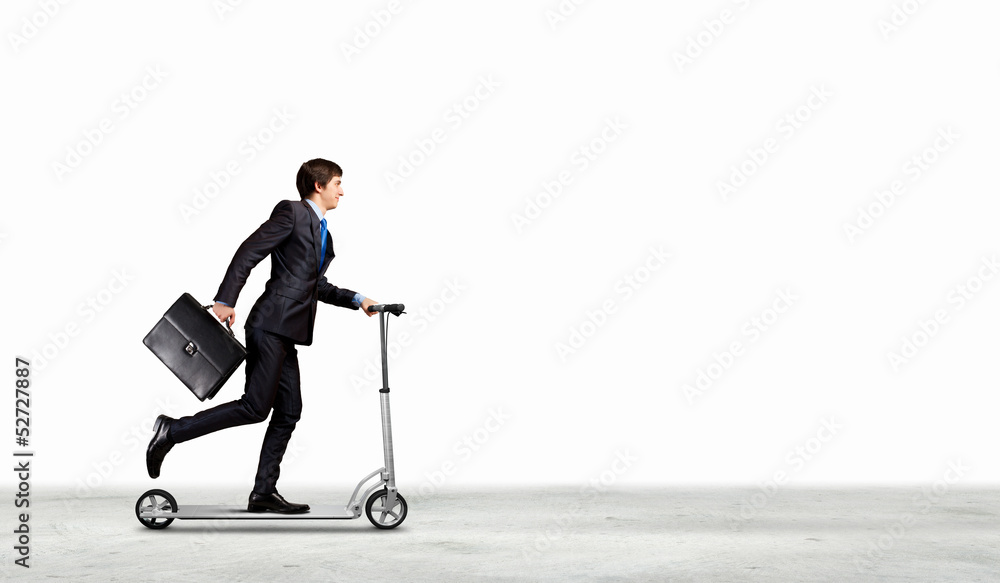 Businessman riding scooter Businessman riding scooter