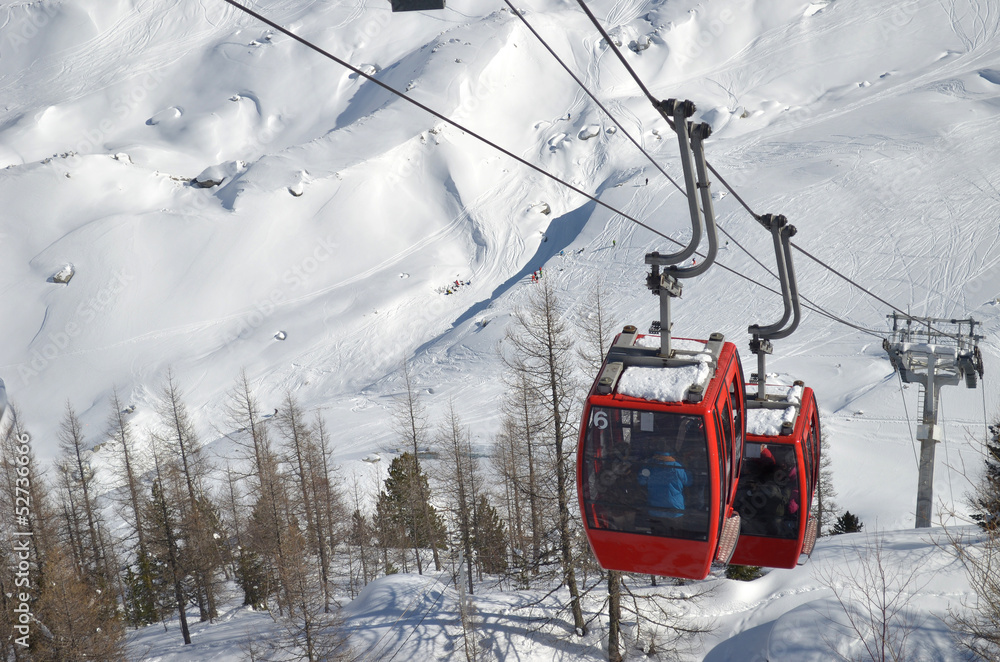 Cablecars moving up snow covered mountain Cablecars moving up snow covered mountain