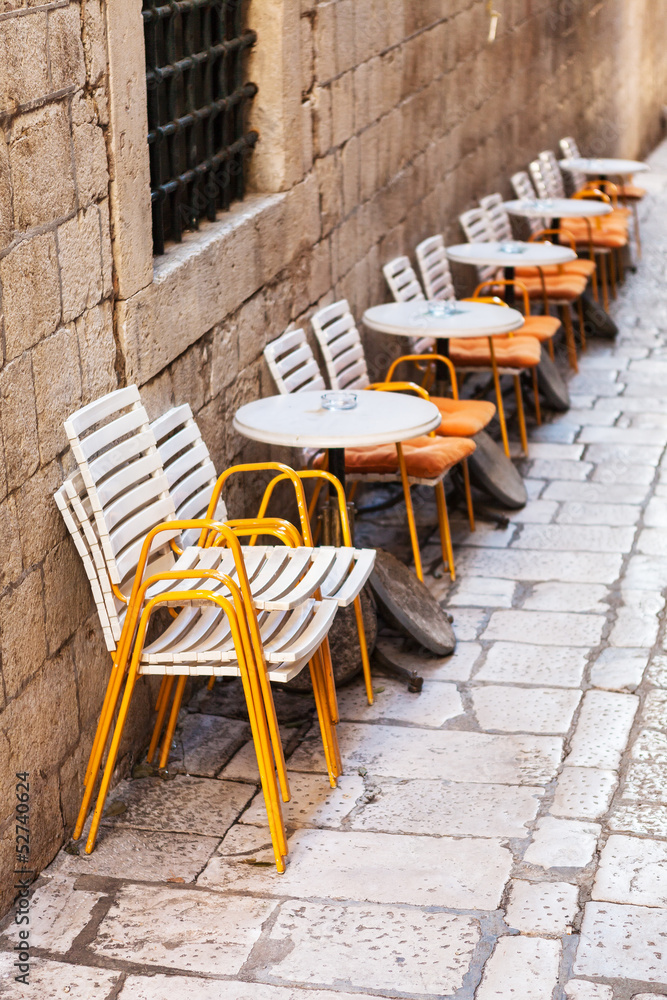 Row of plastic restaurant chairs and tables