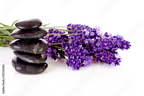 stacked black pebbles stones and lavender flowers