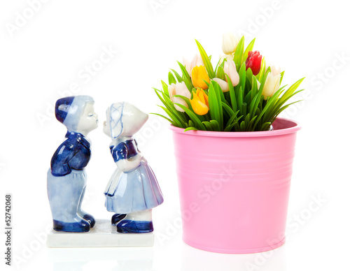 Fototapeta Naklejka Na Ścianę i Meble -  Typical Dutch souvenir in Delft blue and plastic tulips in bucke