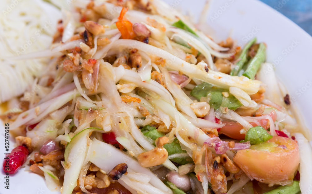 Papaya salad on plate of thai food Papaya salad on plate of thai food