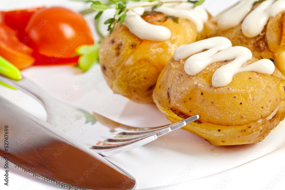 Baked potato with sour cream sauce, selective focus Baked potato with sour cream sauce, selective focus