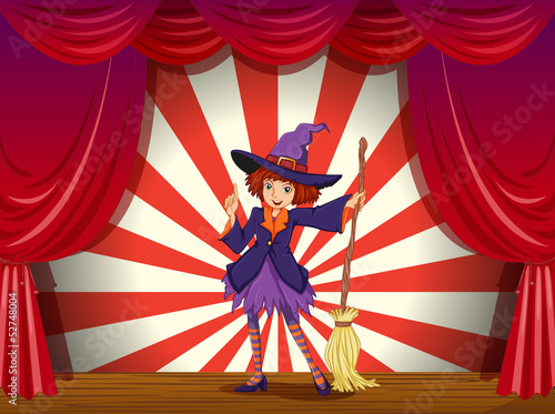 A stage with a witch and her flying broom