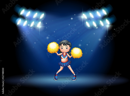 A stage with a young cheerdancer at the center