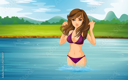 A girl wearing a violet bikini at the river