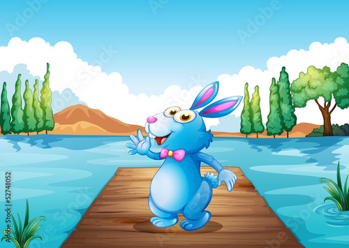 A bunny above the wooden bridge at the river