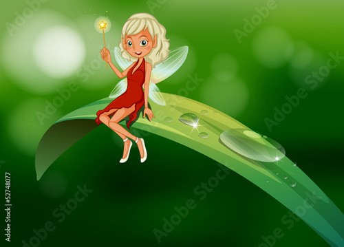 A fairy with a wand sitting at the leaf