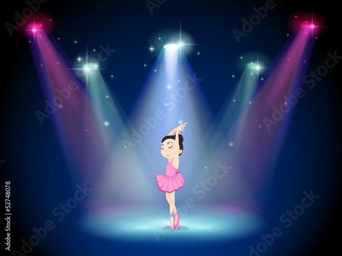 A young ballerina at the center of the stage