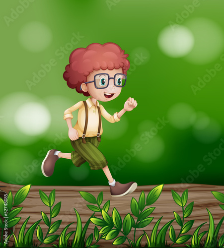 A young boy walking above the trunk