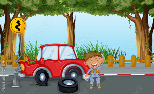 A boy with tools and a red car at the road