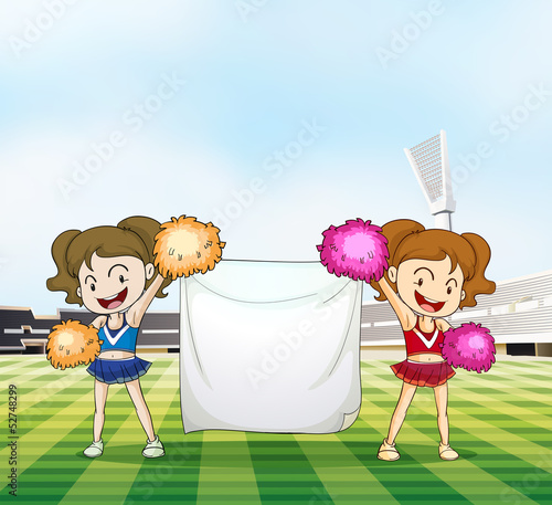 Two young cheerers with an empty banner
