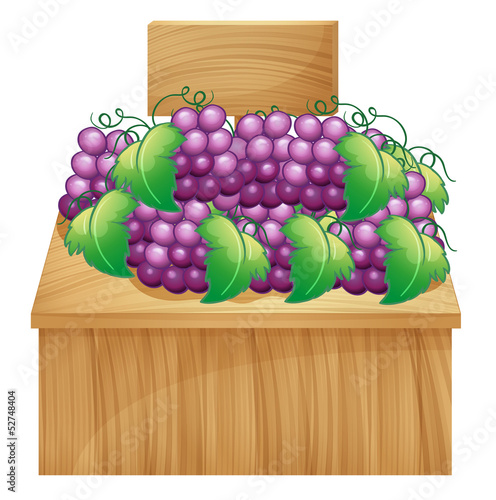 A fruit stand for grapes with an empty signage