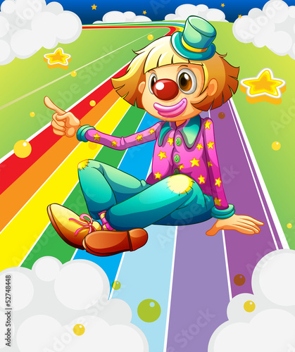 A female clown sitting at the colorful road