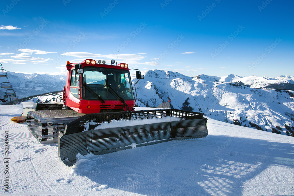 Snow-grooming machine on snow hill Snow-grooming machine on snow hill