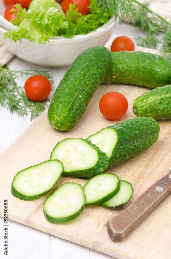 ingredients for salad - fresh cucumbers, tomatoes and fresh herb ingredients for salad - fresh cucumbers, tomatoes and fresh herb