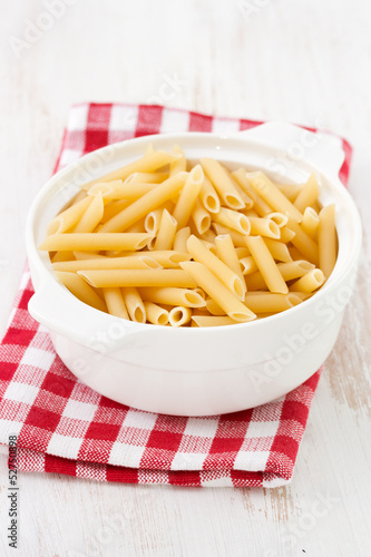 dry penne in white bowl