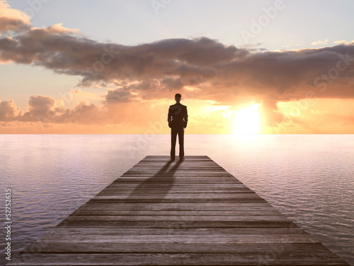 man standing on pier
