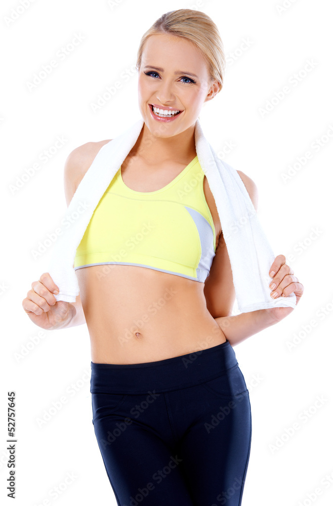 Smiling blond woman standing with towel around her neck Smiling blond woman standing with towel around her neck