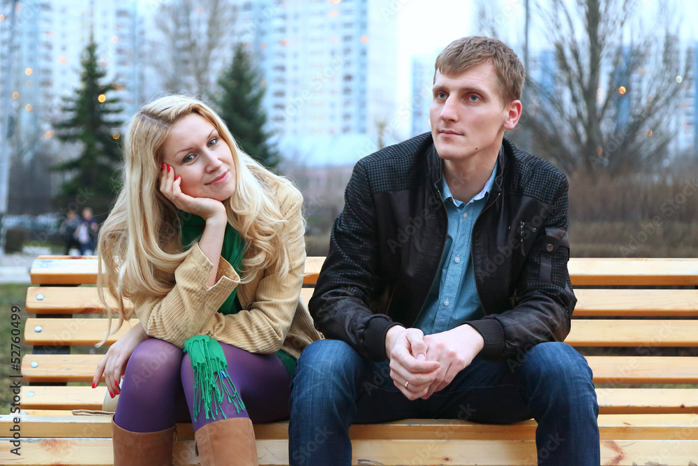 Romantic young couple sitting on bench at evening. Romantic young couple sitting on bench at evening.