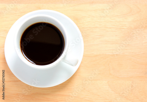 Black coffee in white cup on a wooden table