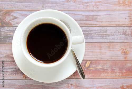 Black coffee in white cup with spoon