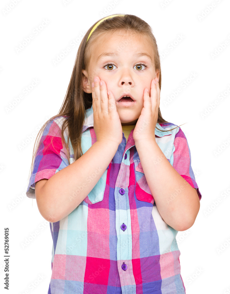 Little girl is holding her face in astonishment Little girl is holding her face in astonishment