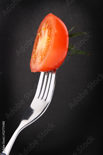 cut tomatoe on a fork